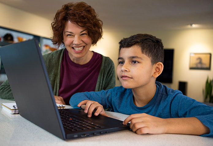 Teacher working with student to complete course work