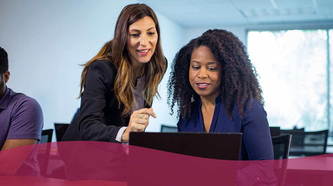 Two women looking at laptop